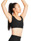 Model wearing black tank bra top with scoop neckline