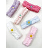 Grouped daisy spa headbands shown from above