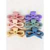 Group of pastel jumbo bow hair claws displayed in a fan arrangement