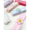 Multiple pastel spa headbands with daisy details displayed together