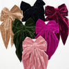 Assorted large velvet bow clips with long tails in multiple colors displayed together