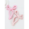 Pink Love and Repeat matte bow-shaped hair claw on a light background