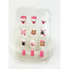 Close-up of short press-on nails for kids with playful designs arranged on a display card