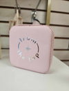 Pink square jewelry box with zipper closure and From the Top logo on the front