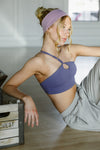 Adult dancer wearing a lavender dance bra with coordinating bottoms, posing outdoors.