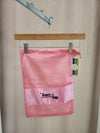 Ballet pink mesh FTT logo shoe bag hanging on rack