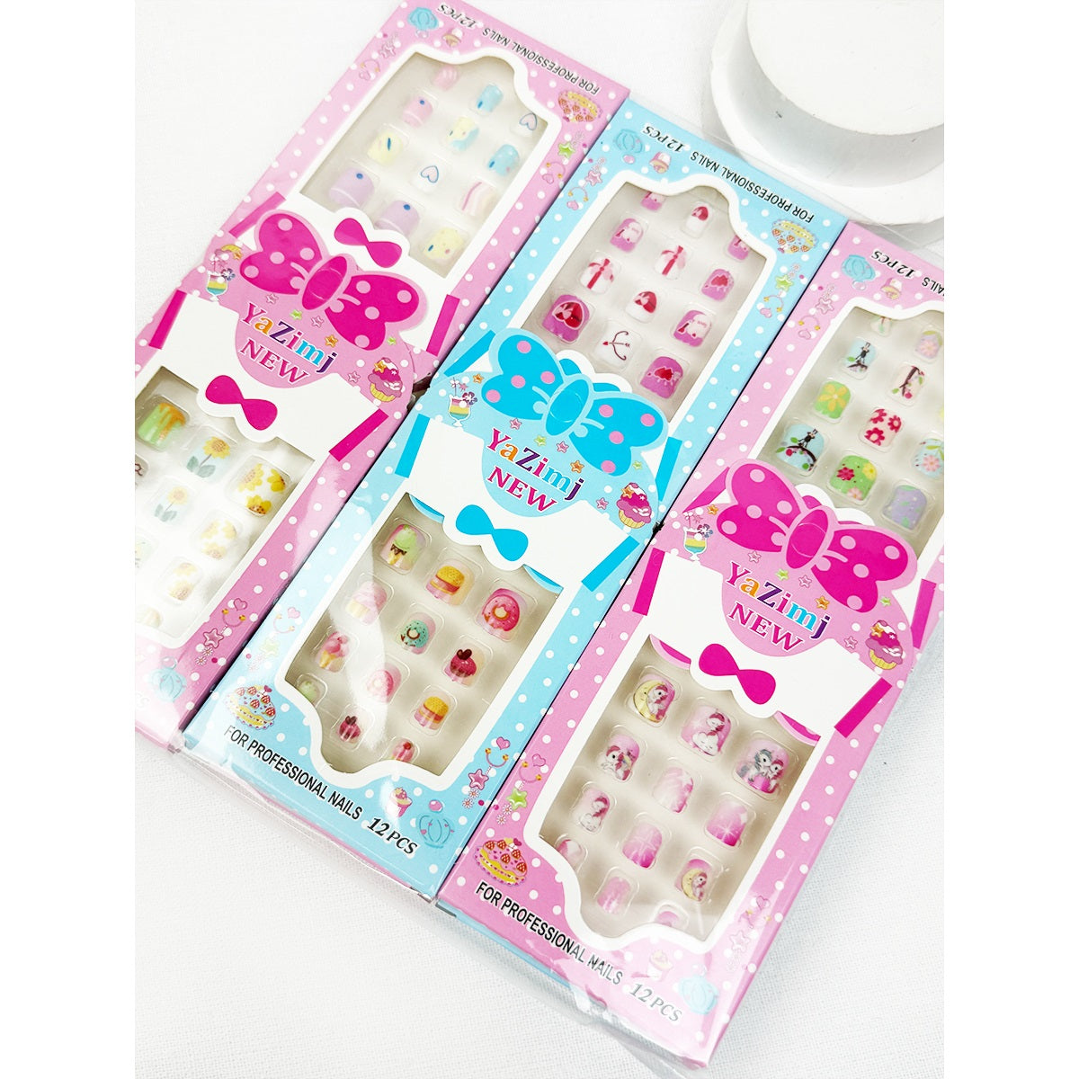 Assorted Love and Repeat kids press-on nail sets arranged in colorful packaging