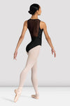 Back view of dancer wearing a black leotard with mesh back detail walking in ballet shoes and tights