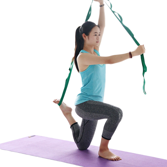 Person using multi-loop stretching strap for leg stretch