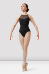 Adult dancer wearing black sweetheart halter leotard front view on pointe