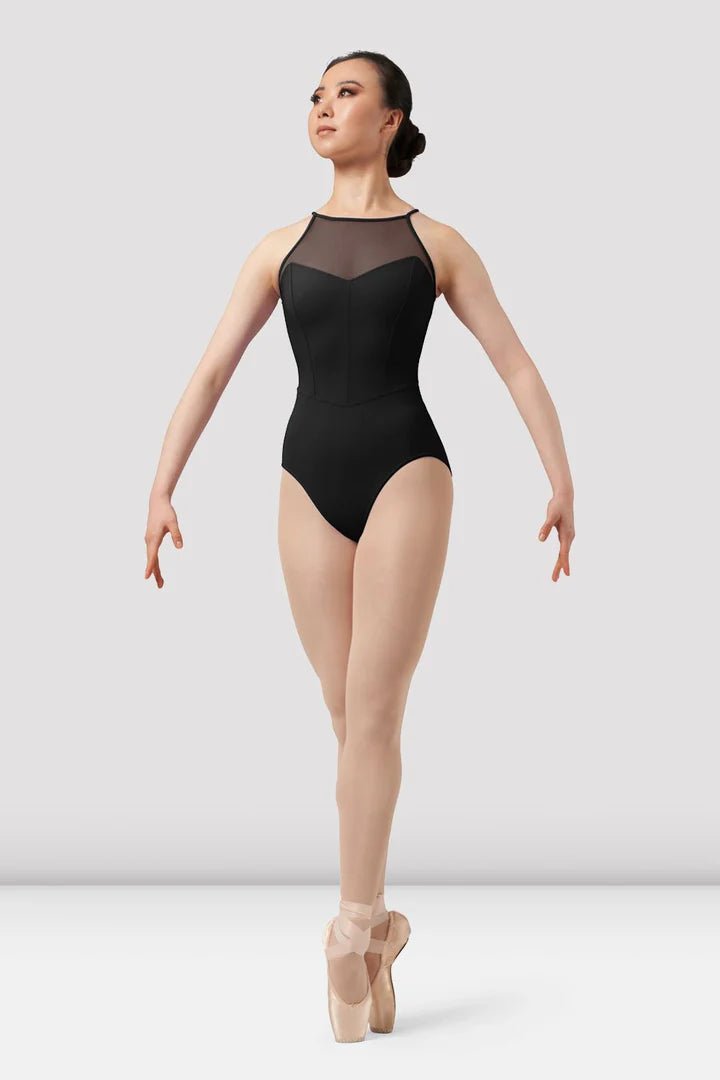 Adult dancer wearing black sweetheart halter leotard front view on pointe