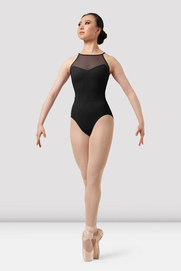 Adult dancer wearing black sweetheart halter leotard front view on pointe