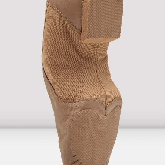 Back heel view of a tan slip-on leather jazz shoe.