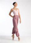 Adult dancer wearing mauve heat retention warm-up pants standing in profile.