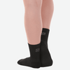 Black performance dance sock worn on foot, ankle height view