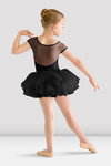 Young dancer wearing a black tutu leotard with mesh back and layered tutu skirt, back view