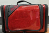 Red hanging travel cosmetics bag shown closed with black trim and zipper.