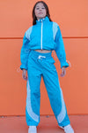 Front view of youth dancer wearing blue Roster Pants with contrast piping