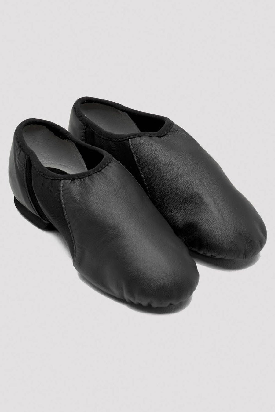 Pair of black slip-on leather jazz shoes on a white background.