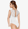Model wearing white lace tank leotard with lace back detail