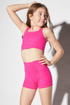 Front view of a dancer wearing a pink Jo + Jax longline tank and shorts