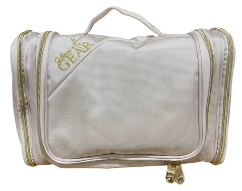 Sand-colored hanging travel cosmetics bag with clear front panel and top handle