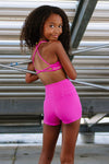Full-body view of dancer wearing a twist-style dance top and coordinating shorts