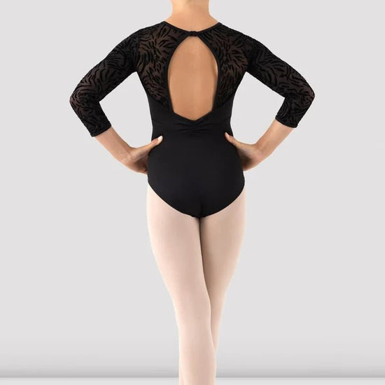 Child wearing black 3/4 sleeve leotard back view showing open back design