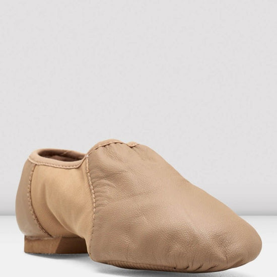 Front angled view of a tan slip-on leather jazz shoe on a white background.