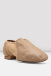 Front angled view of a tan slip-on leather jazz shoe on a white background.