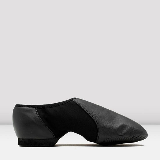 Side view of a black slip-on leather jazz shoe on a white background.
