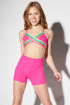 Dancer wearing a neon pink crossover dance top styled for convention wear