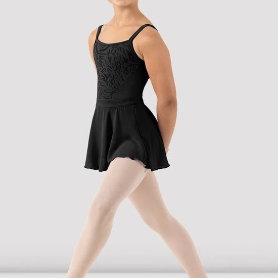 Girl wearing black skirted camisole leotard front view with attached skirt